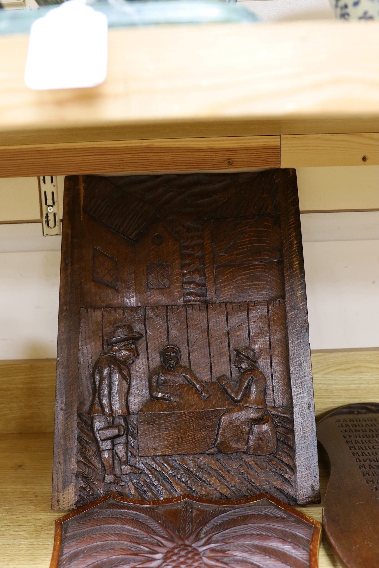 Six mixed oak carved panels and a metal relief mounted panel
